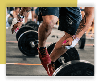 Athlete jumping over a barbell while wearing thumb tape on his fingers