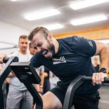 Martin riding assault bike in a gym